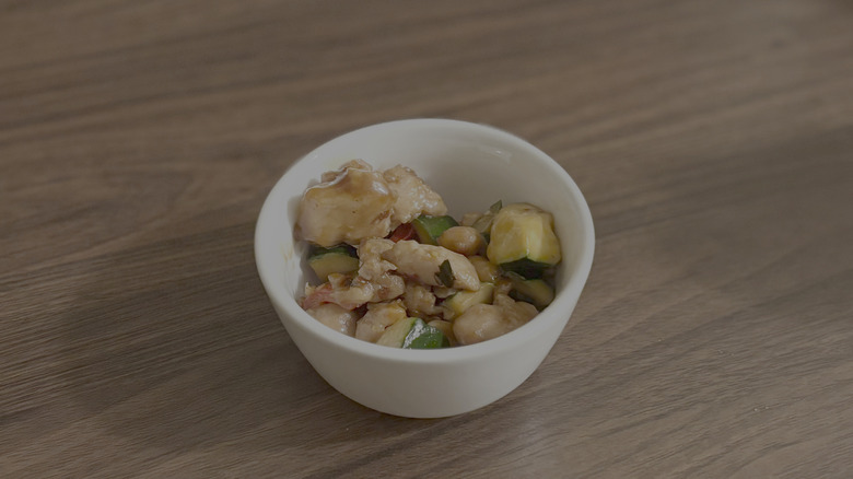 Small white bowl with chicken and veggies