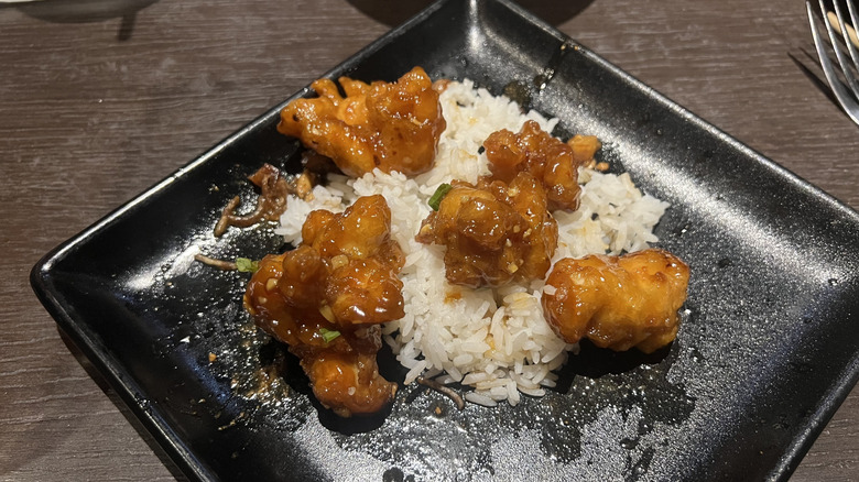 Plate of white rice and orange chicken at P.F. Chang's