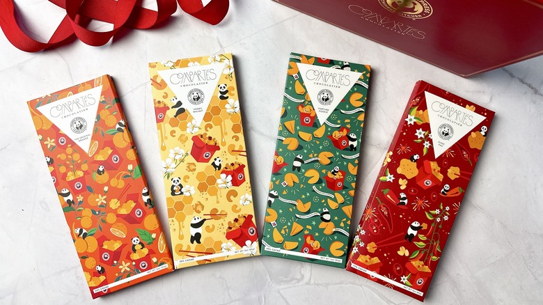 4 Compartés chocolate bars with a holiday box and red ribbon