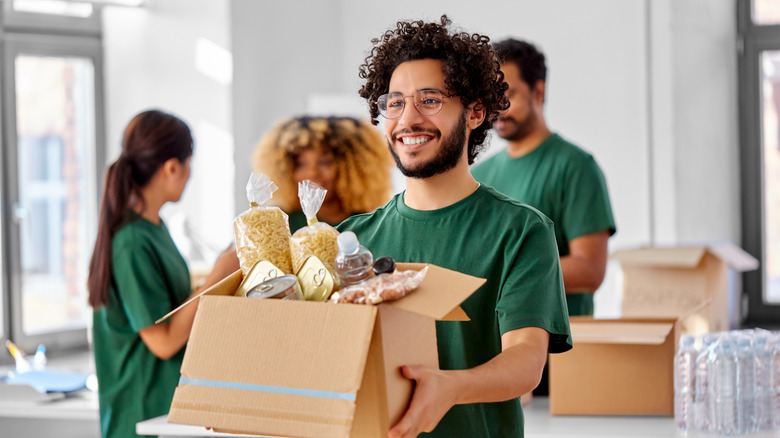 Person holding food donation box