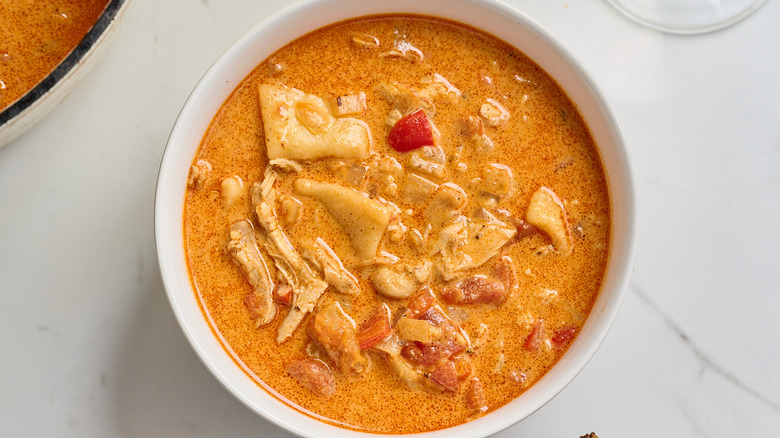 Bowl of chicken paprikash and dumpling soup on a table