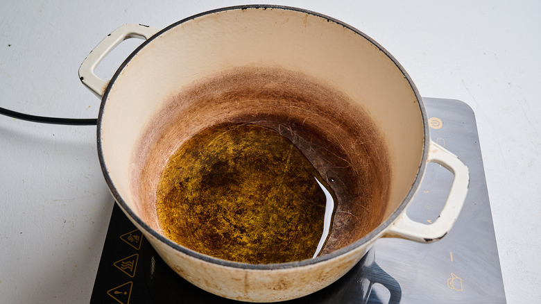 Heating oil in a pot on a stove