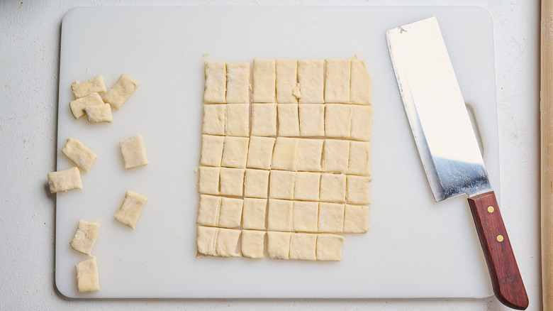 cutting dough into strips with a knife