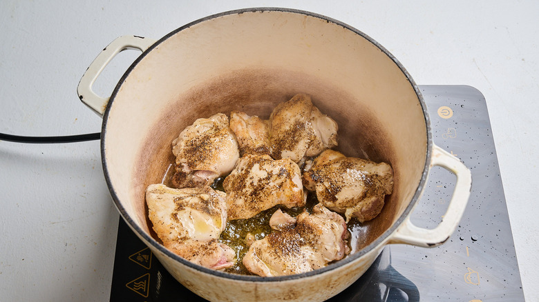 browning the chicken in a pot