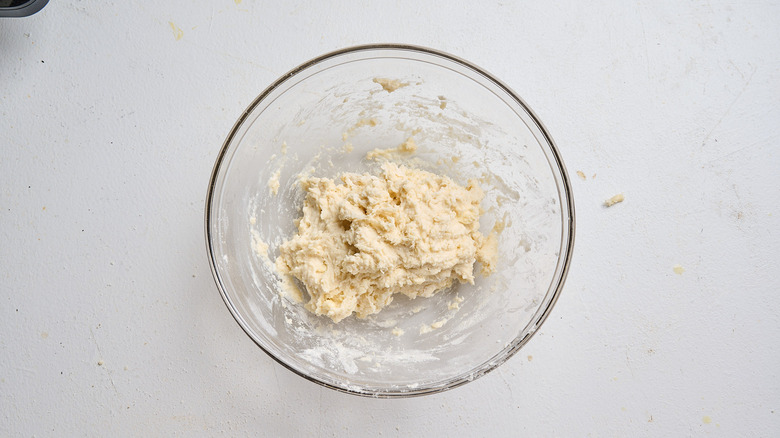forming flour and milk into dough