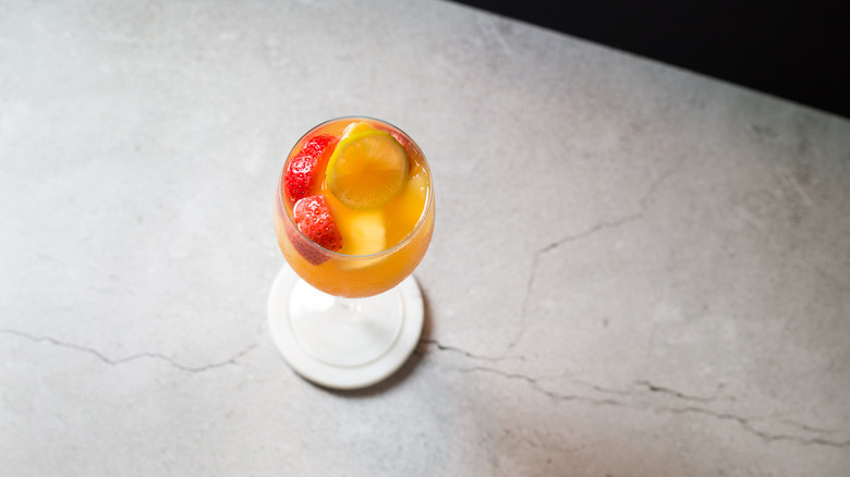 glass of passion fruit sangria on table