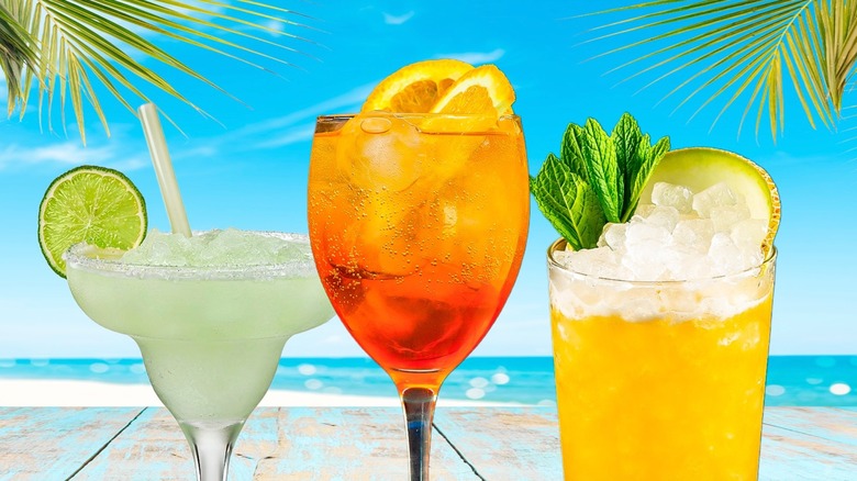 Three cocktails against beach background