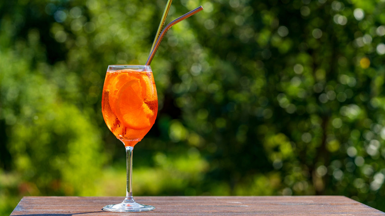 Aperol spritz against greenery backdrop