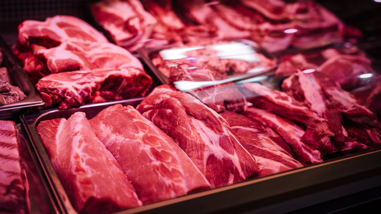 Different cuts of meat displayed behind counter