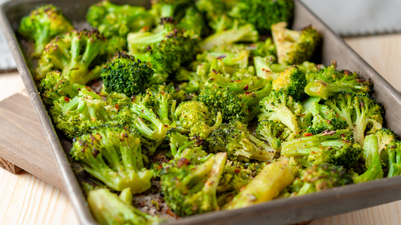 Oven-roasted broccoli florets on an aluminum sheet pan