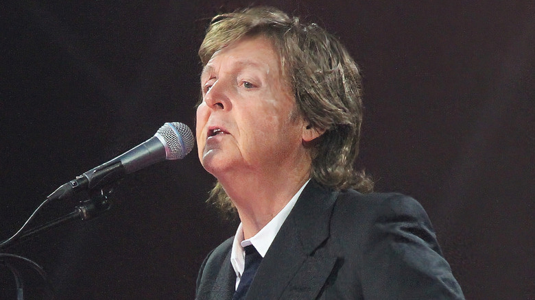Paul McCartney performing on stage with a guitar at Outside Lands Music Festival