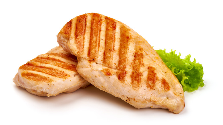 grilled chicken breasts on white background