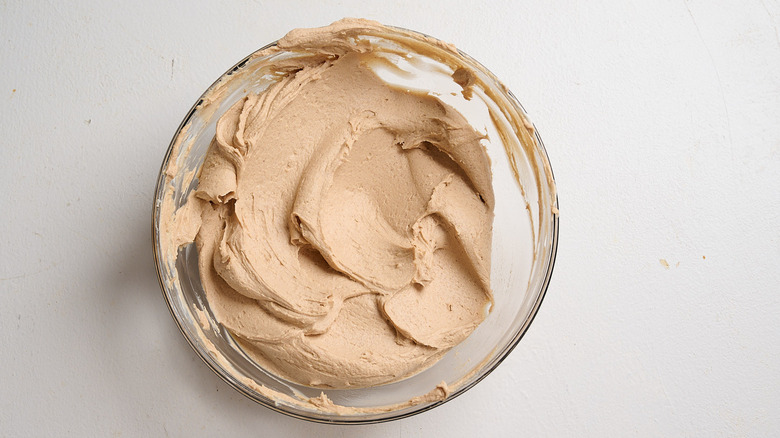 yogurt, peanut butter, and maple syrup combined in a bowl