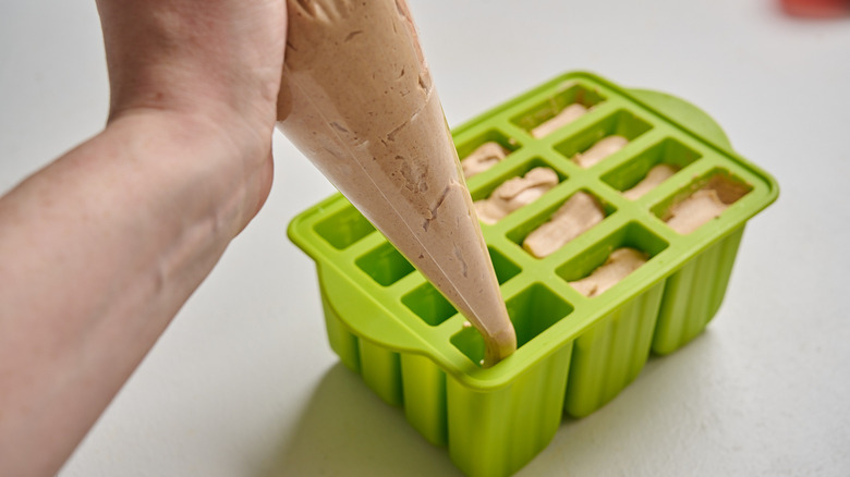 filling molds with peanut butter mixture