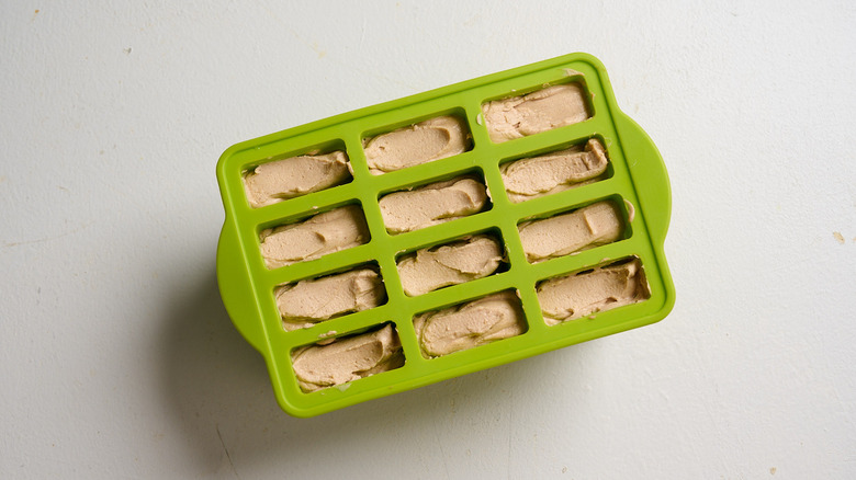Popsicle molds filled with peanut butter mixture