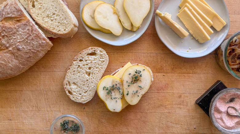 open faced pear sandwich with bread, pear slices, and cheese on plates