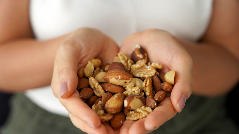 Hands full of assorted nuts