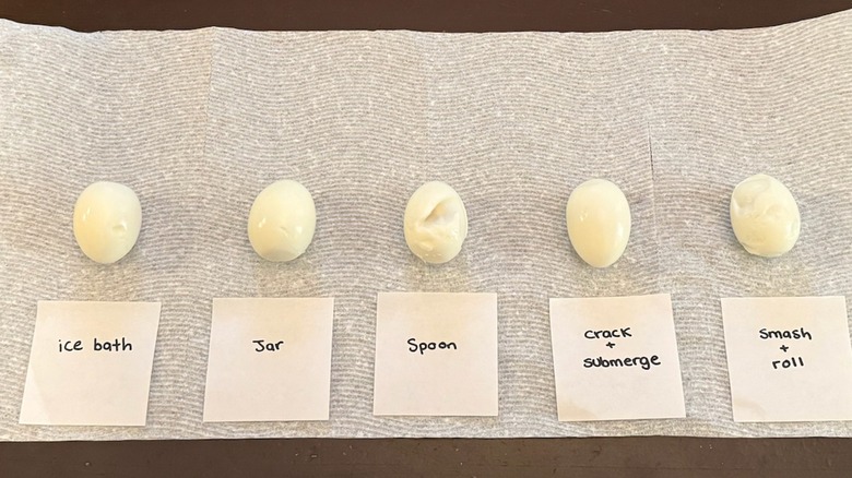 different hard-boiled eggs peeled with labels on methods