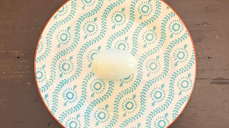 a hard-boiled egg peeled on a plate