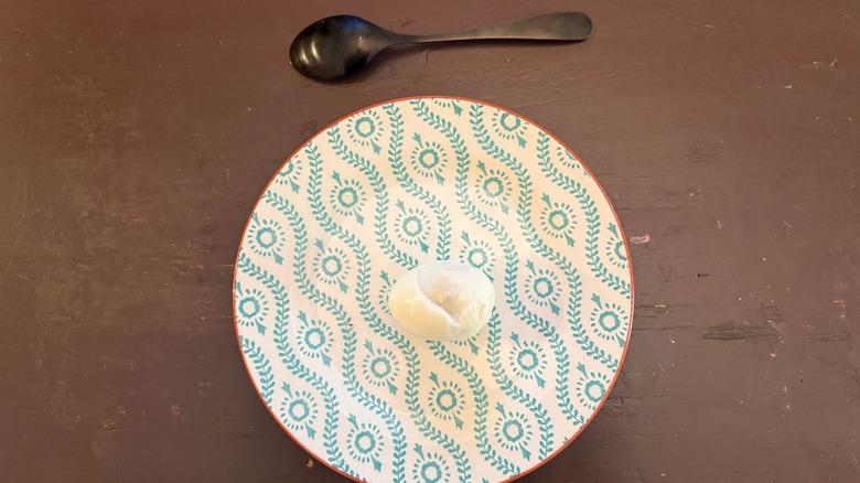 hard boiled egg peeled with a spoon