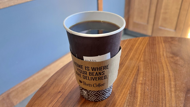 Dark roast coffee from Peet's on a wooden table
