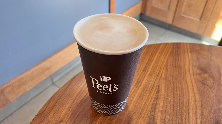 View of a café au lait from Peet's on a wooden table