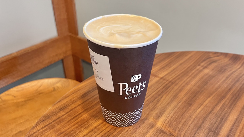 Golden latte with protein from Peet's on a wooden table
