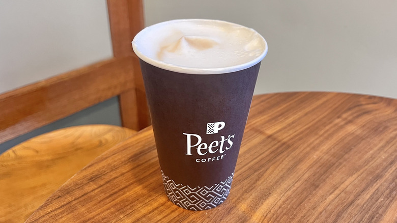 Latte macchiato with foam from Peet's on a wooden table