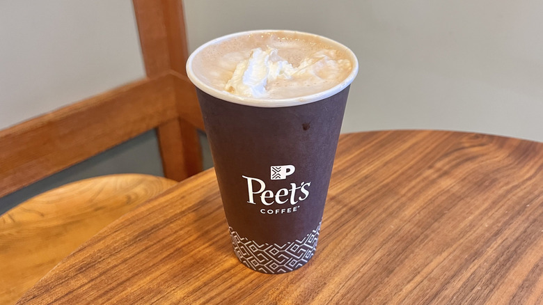 Hazelnut mocha with whipped cream from Peet's on a wooden table