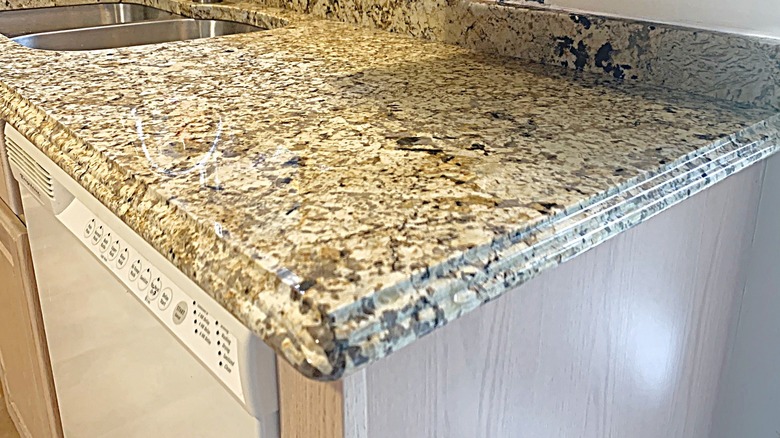 A triple pencil edge countertop made from brown/tan granite