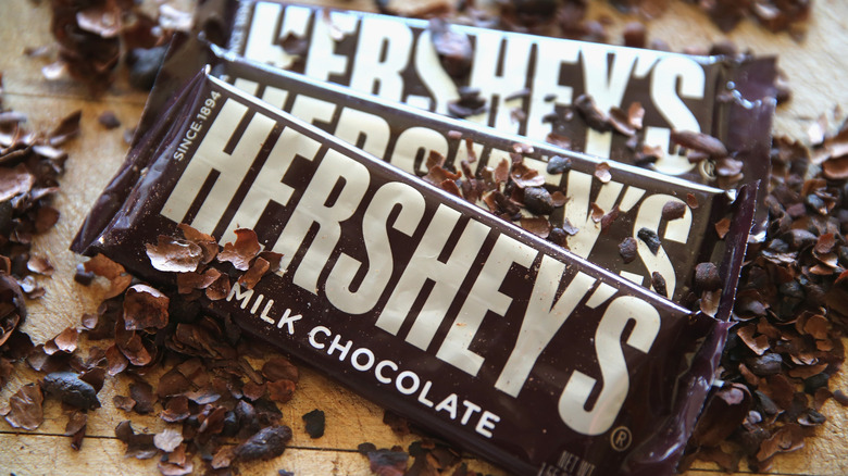 three Hershey's bars with chocolate shavings surrounding them