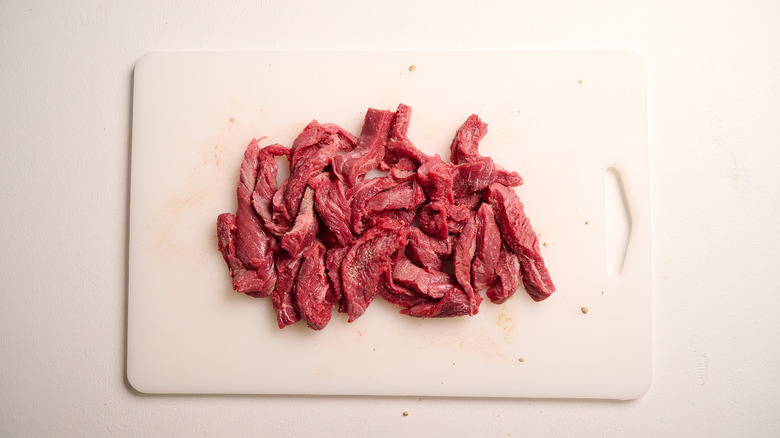 seasoning steak in skillet