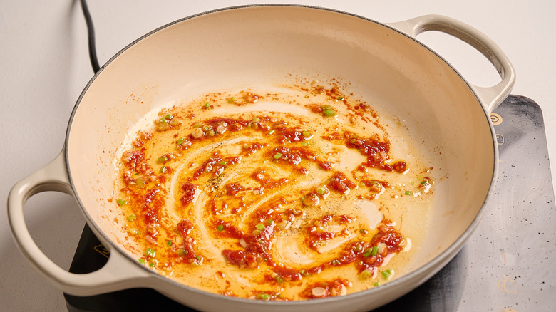 stirring gochujang into a skillet