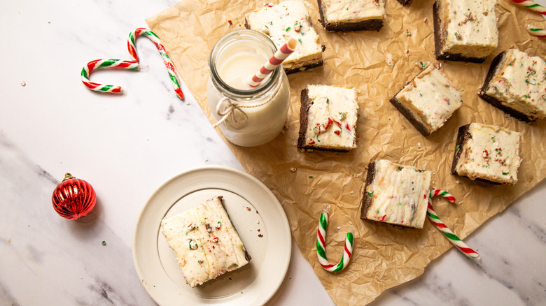 Peppermint bark cookie bars on table with milk