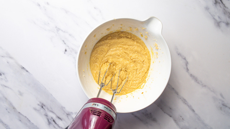 Mixing eggs into butter sugar mix