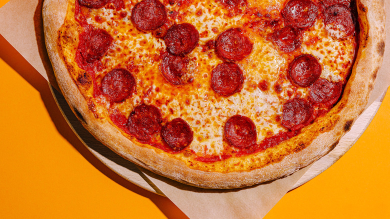 Pepperoni cheese pizza orange backdrop
