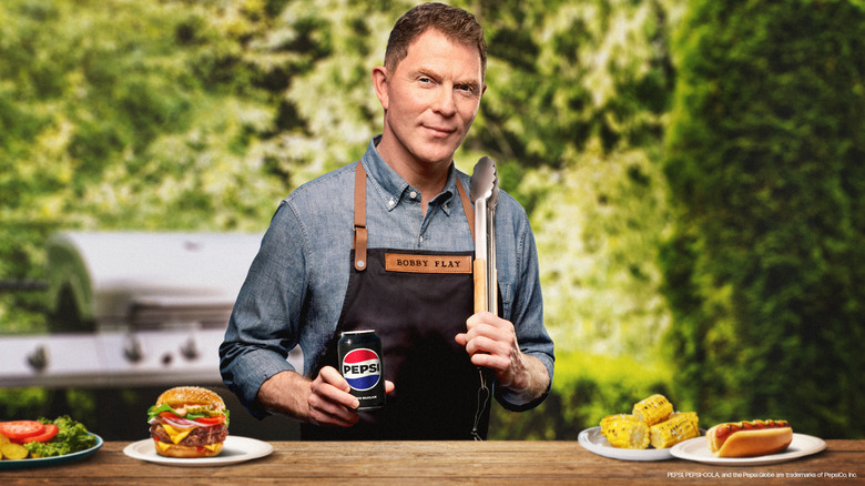 Bobby Flay grilling and holding a can of Pepsi