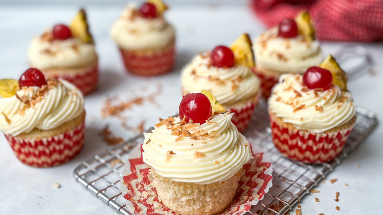 white-frosted cupcakes with cherries