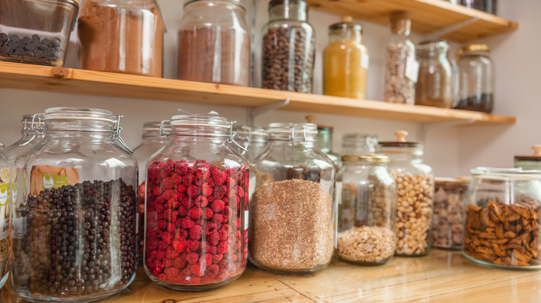 Pantry shelves lined with jars of assorted goods