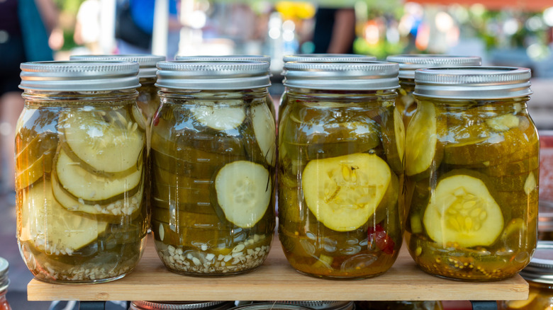 Row of jars of pickles on table