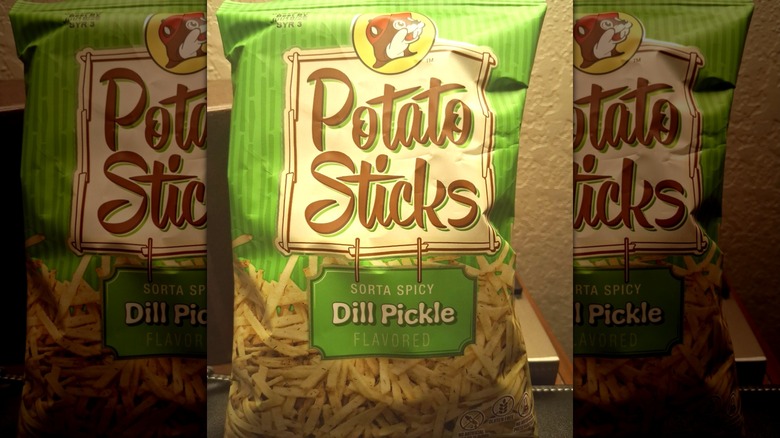 A bag of Buc-ee's Sorta Spicy Dill Pickle Potato Sticks sits on a counter.