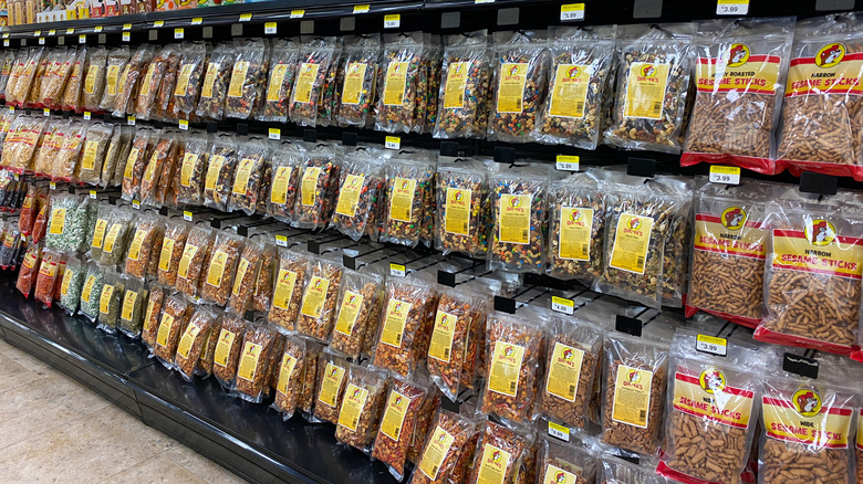The snack aisle at Buc-ee's holds bags of trail mix, sesame sticks, and more.