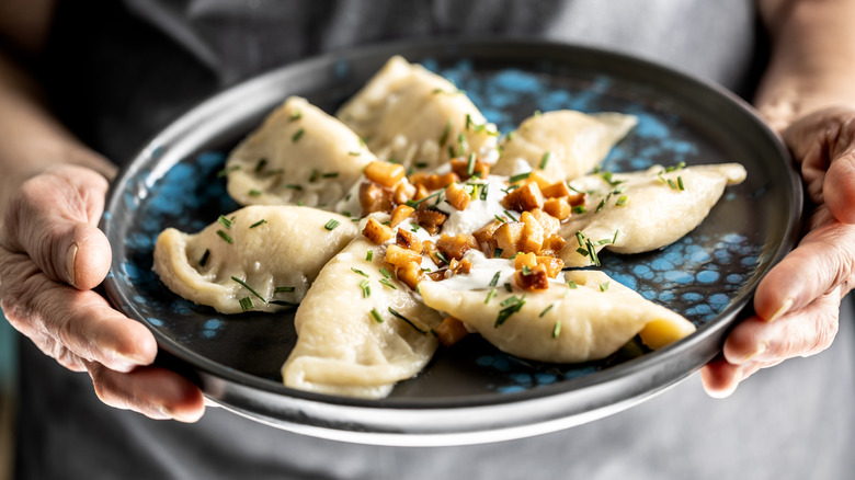 Pierogi on a plate with toppings