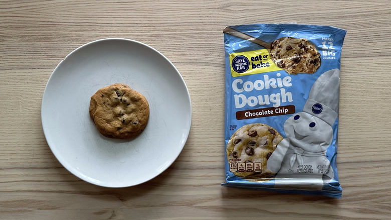 Pillsbury Chocolate Chip Cookie Dough package next to a baked cookie on a plate