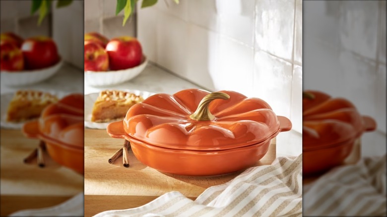 Pumpkin-shaped stoneware pie plate with gold stem on kitchen counter