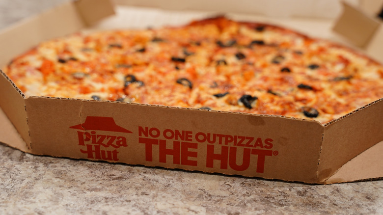 Close up of Pizza Hut thin crust pizza in a delivery box