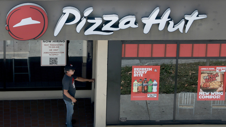 close up of employee entering Pizza Hut