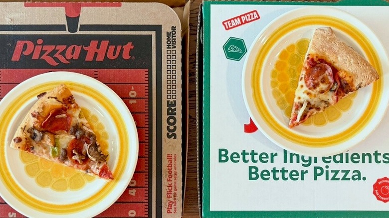 two pieces of pizza on top of boxes