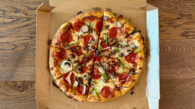 Sliced supreme pizza with lots of pepperoni
