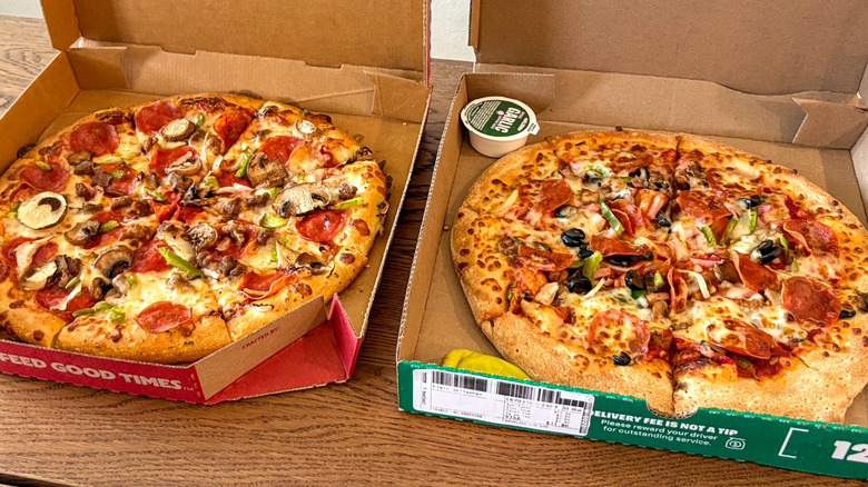Pizzas in cardboard boxes on a table